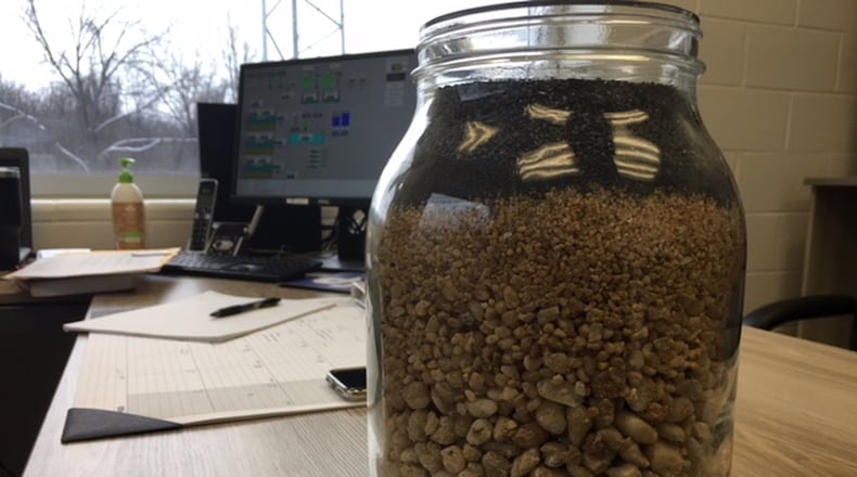 A jar shows a cross section of the material used in the large filters at Yellow Springs new water plant. Richard Wilson/Staff