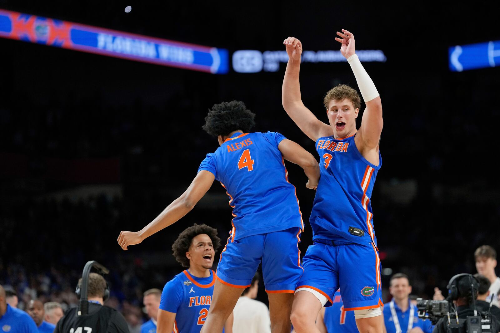 Florida's Sam Alexis (4) and Micah Handlogten (3) celebrate after a national semifinals game against Auburn at the Final Four of the NCAA college basketball tournament, Saturday, April 5, 2025, in San Antonio. (AP Photo/Eric Gay)