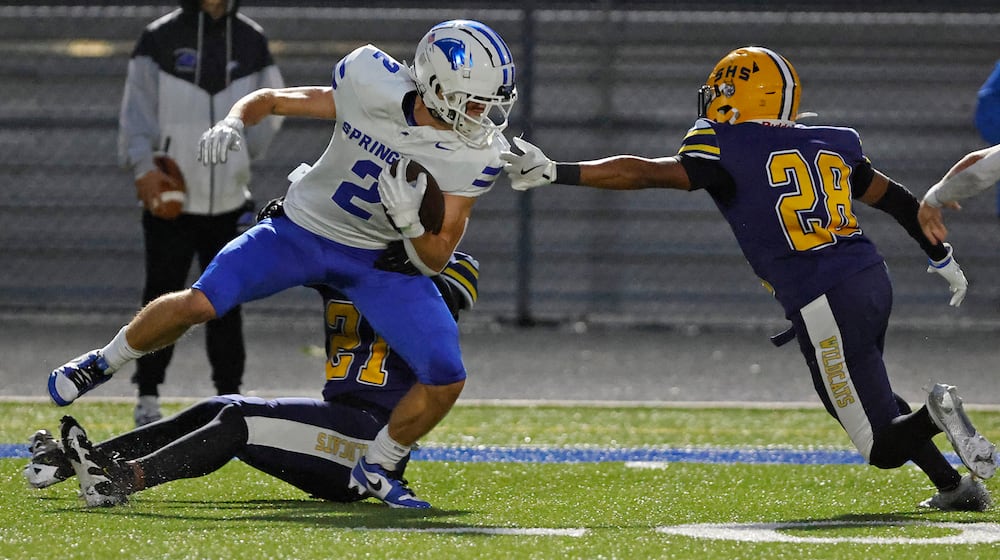 Springboro's Drew Balogh is tackled by Springfield's Rashad Walker Cherry and Ty'Juan Wright. BILL LACKEY/STAFF