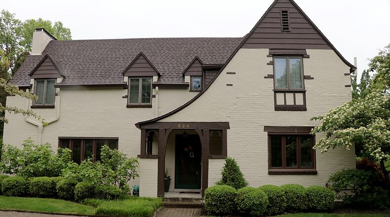 The Tudor-style home has about 3,930 sq. ft. of living space plus a newly finished basement. The house sits on a corner lot with a private fenced back yard and a paver-brick patio among mature gardens and walkways. A paver-brick driveway curves to the formal entry of the house while the driveway leads to the 2-car garage and informal side entry to the house. CONTRIBUTED PHOTO BY KATHY TYLER