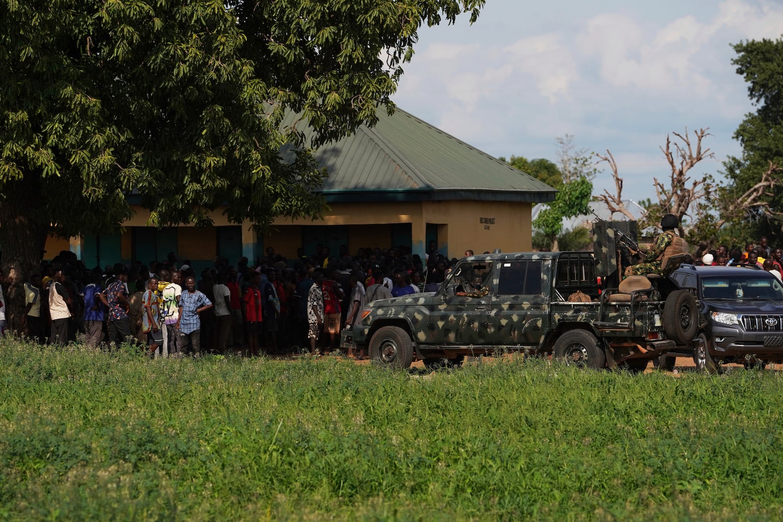 Soldiers stand guard prior to a visit from government officials following an attack by gunmen in Yelewata community north-central Nigeria, Monday, June 16, 2025. (AP Photo)
