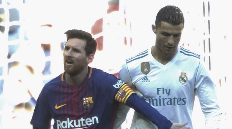 In a December 2017 file image, Real Madrid's Cristiano Ronaldo, right, and Barcelona's Lionel Messi walk side by side at the end of a Spanish La Liga match at the Santiago Bernabeu stadium in Madrid, Spain. (Juan Carlos Rojas/Xinhua/Zuma Press/TNS)