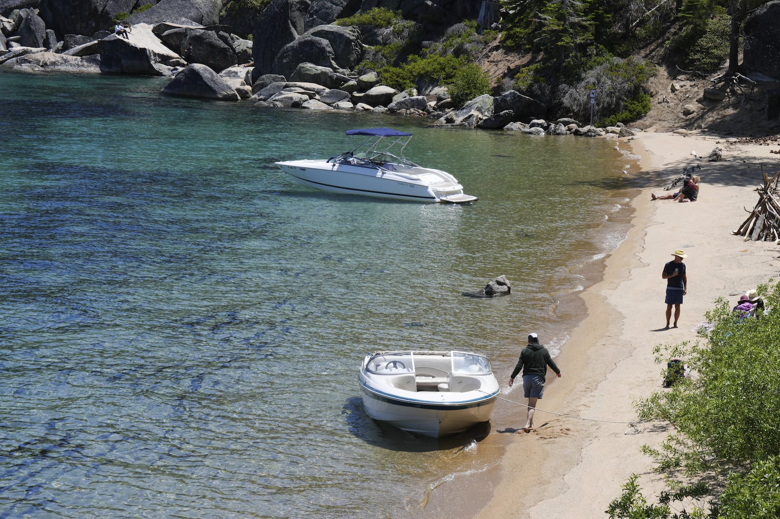 Visitors along the lake at D.L. Bliss State Park after a weekend incident in which a boat capsized, killing several people, on Monday, June 23, 2025, in Lake Tahoe, Calif. (AP Photo/Brooke Hess-Homeier)