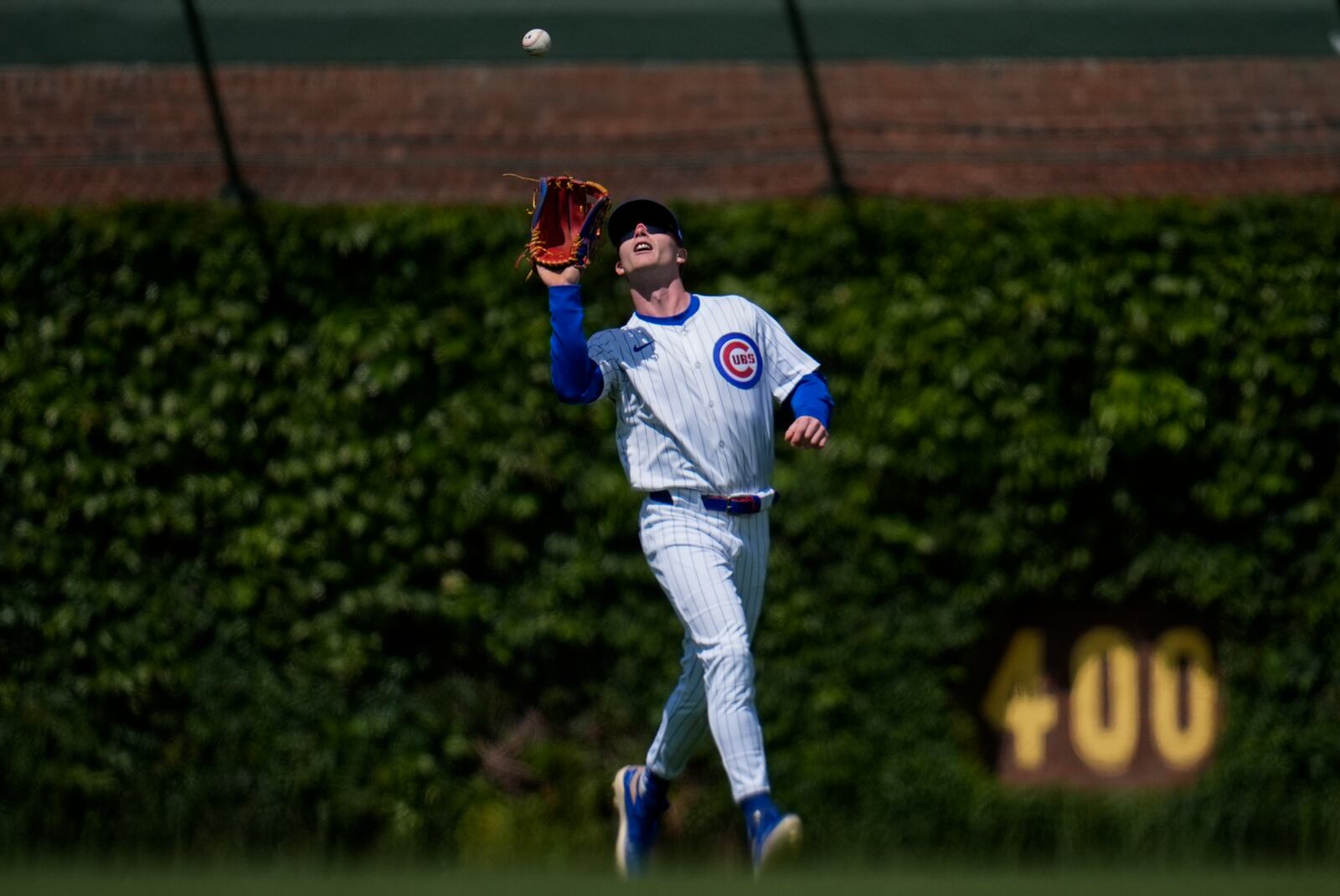 Chicago Cubs center fielder Pete Crow-Armstrong (4) catches a fly out from Cincinnati Reds' Matt McLain (9) during the sixth inning of a baseball game Saturday, May 31, 2025, in Chicago. (AP Photo/Erin Hooley)