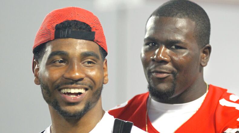 Braxton Miller, left, and Cardale Jones share a laugh during Ohio State football media day on Sunday, Aug. 16, 2015, at the Woody Hayes Athletic Center in Columbus. David Jablonski/Staff