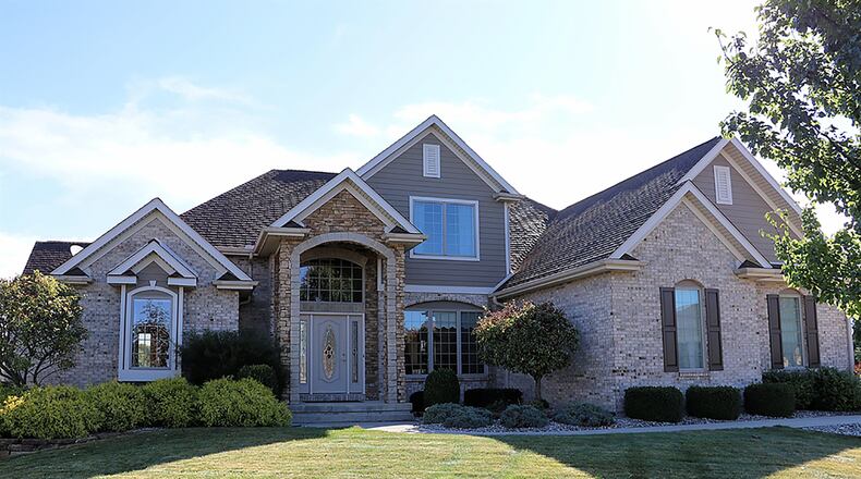 The brick 2-story has about 3,220 sq. ft. of living space. The house sits at the end of the cul-de-sac, and a concrete driveway leads to the side-entry, 3-car garage. CONTRIBUTED PHOTO BY KATHY TYLER