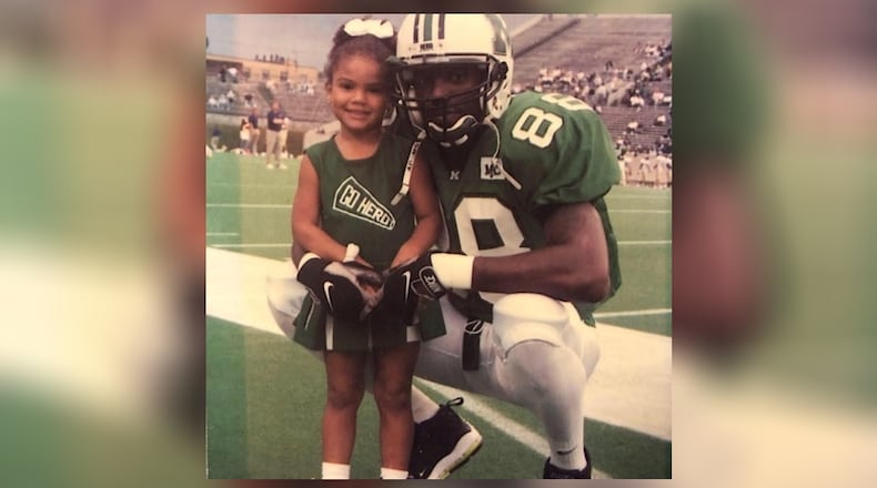Sydney Moss, as a young cheerleader for Marshall University, visiting her dad on the sidelines. Randy Moss was then an All-America receiver at Marshall and would soon embark on a 14-year career in the NFL that would get him enshrined in the Pro Football Hall of Fame. CONTRIBUTED