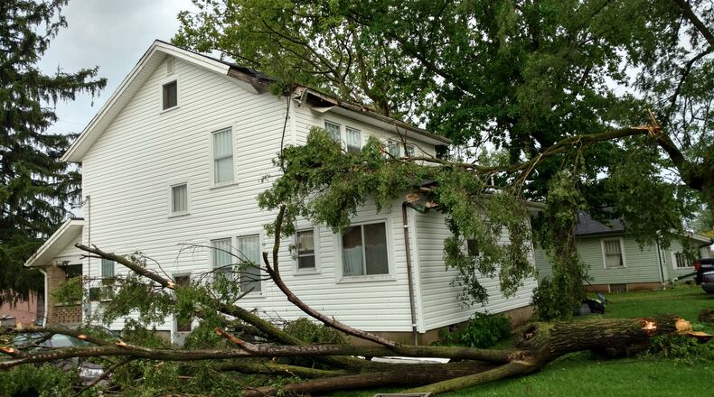 This tree slammed into this house and car (far left) on Union Road in Moraine during the storm that hit the region on Friday afternoon, May 19, 2017. (Courtesy/Ron Boehringer)