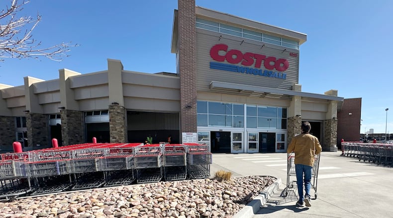 FILE - A lone shopper pushes a cart toward the entrance of a Costco warehouse, March 13, 2025, in Sheridan, Colo. (AP Photo/David Zalubowski, File)