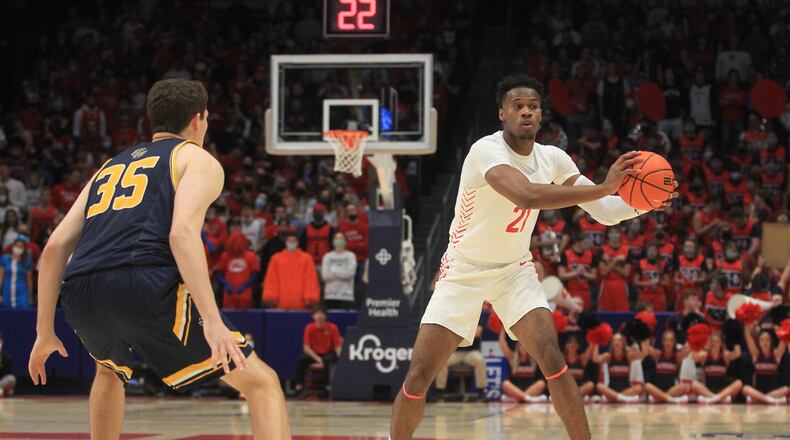 Dayton's Richard Amaefule makes a pass against Cedarville in an exhibition game on Monday, Nov. 1, 2021, at UD Arena. David Jablonski/Staff