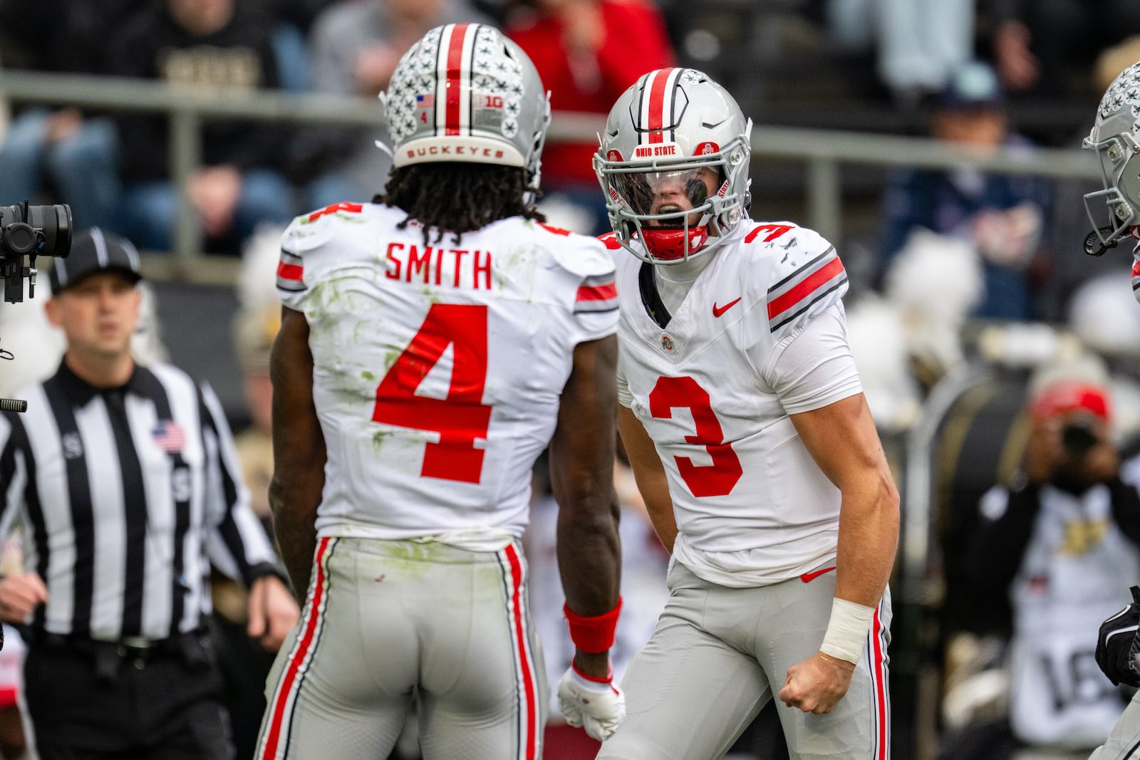 Ohio State quarterback Lincoln Kienholz (3) reacts after scoring during the first half of an NCAA college football game against Purdue, Saturday, Nov. 8, 2025, in West Lafayette, Ind. (AP Photo/Doug McSchooler)