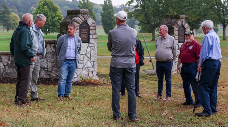 Members of the Montgomery County Veterans Service Commission and local Scouting America leaders talk before a tour of Victory Oak Knoll Memorial on Tuesday, Sept. 24, 2025, in Kettering. Troop leaders oversaw repairs to the World War I Memorial, which is located near the 18th hole at Community Golf Course. The veterans commission provided funds for repairs of damage caused by a windstorm last fall. BRYANT BILLING / STAFF