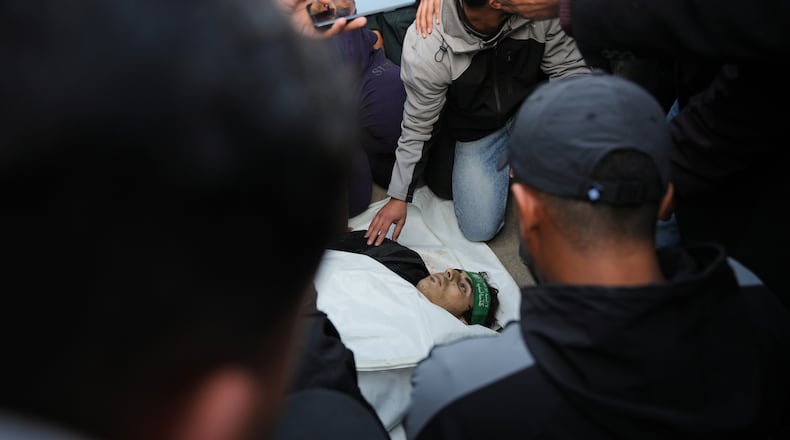 Palestinians mourn over the body of Hamas militant Firas al-Najjar, who was killed in an Israeli military strike, during his funeral at Nasser Hospital in Khan Younis, Gaza Sunday, Feb. 15, 2026. (AP Photo/Abdel Kareem Hana)