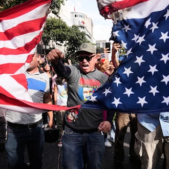 Government supporters rip an American flag in half during a protest in Caracas, Venezuela, Saturday, Jan. 3, 2026, after U.S. President Donald Trump announced that U.S. forces had captured President Nicolás Maduro and first lady Cilia Flores. (AP Photo/Ariana Cubillos)