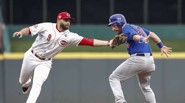CINCINNATI, OH - AUGUST 08: José Peraza #9 of the Cincinnati Reds tags out Jonathan Lucroy #25 of the Chicago Cubs at Great American Ball Park on August 8, 2019 in Cincinnati, Ohio. (Photo by Michael Hickey/Getty Images)