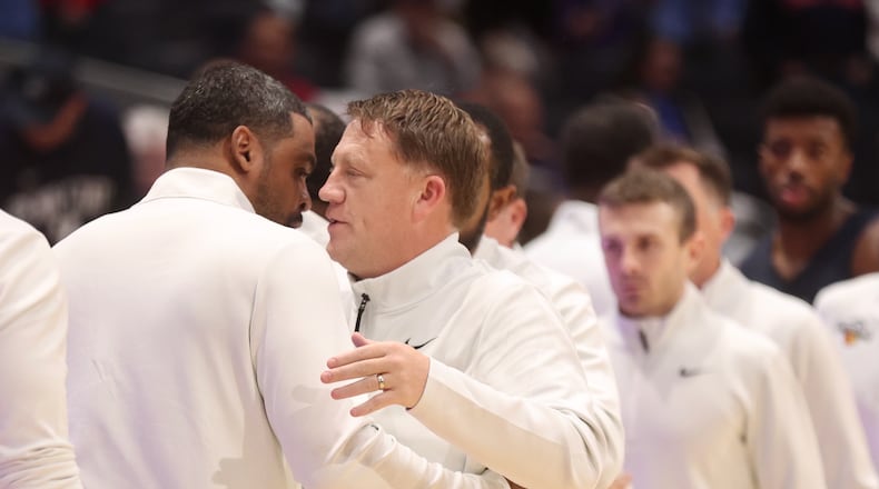 Penn State's Mike Rhoades hugs Dayton's Ricardo Greer after an exhibition game on Sunday, Oct. 19, 2025, at UD Arena. David Jablonski/Staff