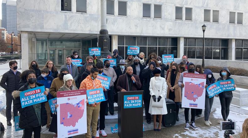 Advocates who believe that newly drawn Ohio legislative maps remain heavily gerrymandered rally outside the Ohio Supreme Court on Wednesday, Dec. 8, 2021, in Columbus, Ohio. The court heard arguments Wednesday over lawsuits challenging the mapsthat voter-rights and Democratic groups say are gerrymandered to favor Republicans. (AP Photo/Andrew Welsh-Huggins)