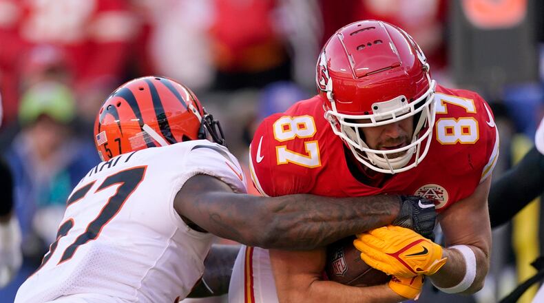 Kansas City Chiefs tight end Travis Kelce (87) tries to break a tackle by Cincinnati Bengals linebacker Germaine Pratt (57) after catching a pass during the first half of the AFC championship NFL football game, Sunday, Jan. 30, 2022, in Kansas City, Mo. (AP Photo/Charlie Riedel)