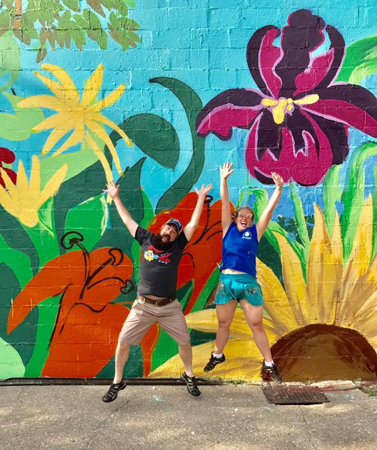 Dayton resident John Stanton and Tiffany Clark of the Mural Machine leap into the air in front of the new mural in  Nordale Park.  It went a long way in affirming to me that out of bad comes good. 
"I attest that when those of kind heart and broad spirit see a world in turmoil they rise and shine their light. Also, we take silly pictures," Stanton wrote on Facebook.