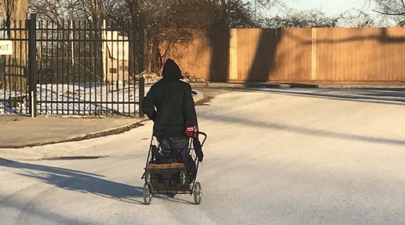 A woman who said she was homeless is pictured outside the St. Vincent de Paul Gateway Shelter for Women and Families on Wednesday, Dec. 27, 2017. STAFF / GABRIELLE ENRIGHT