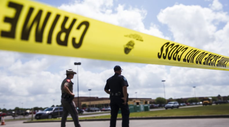 Law enforcement officials enforce a perimeter around Santa Fe High School on May 19. A mass shooting at the school left 10 dead and 10 injured. AMANDA VOISARD / AMERICAN-STATESMAN