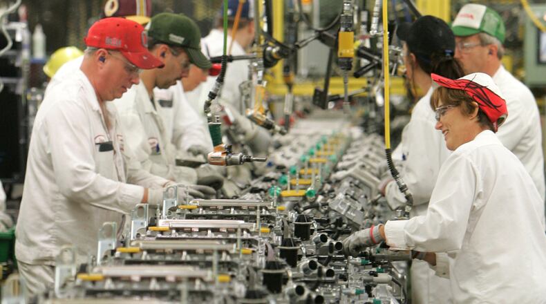 Workers work on a manufacturing line at Honda plant in Anna, Ohio. BILL LACKEY/STAFF