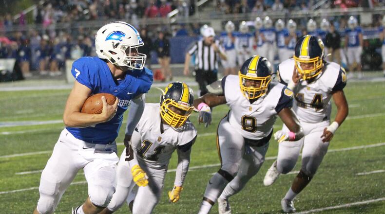 Springboro QB Landon Palmer is chased by Springfield defenders Xzerious Stinnett (11), Bryce Walker (9) and Tayden Harper (44). Springfield defeated host Springboro 23-0 in a Week 7 high school football game on Friday, Oct. 11, 2019. MARC PENDLETON / STAFF