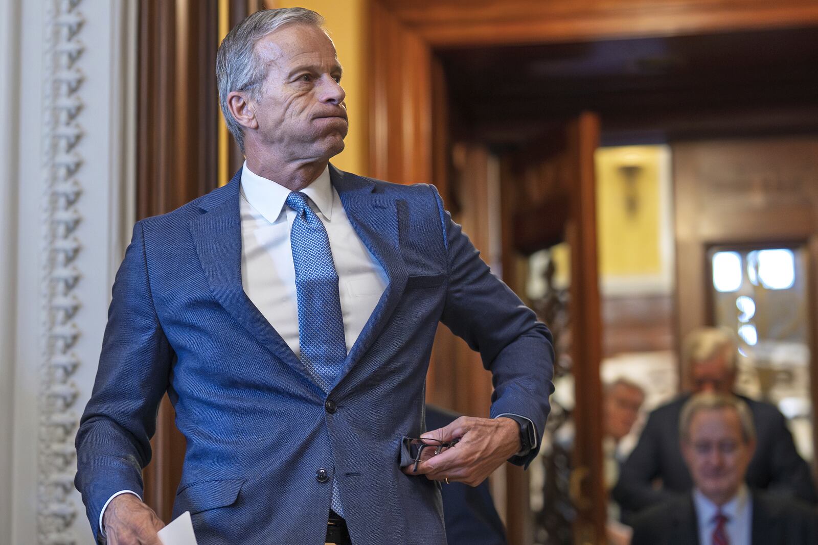 Senate Majority Leader John Thune, R-S.D., emerges from the chamber just after passage of the budget reconciliation package of President Donald Trump's signature bill of big tax breaks and spending cuts, at the Capitol in Washington, Tuesday, July 1, 2025. (AP Photo/J. Scott Applewhite)