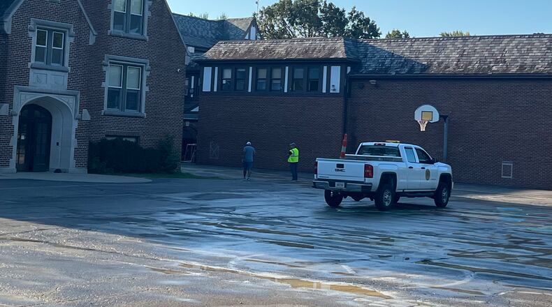 Workers from the Oakwood school district and the city of Oakwood check on a water main break behind Smith Elementary School on Labor Day, Monday, Sept. 4, 2023. JEREMY P. KELLEY / STAFF
