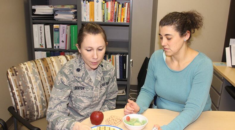 Lt. Col. Amanda Denton, Nutritional Medicine Flight commander and Air Force Materiel Command nutrition consultant, and Kendra Schmuck, nutrition clinic manager, can help patients achieve their personal nutrition goals for a healthier lifestyle. The 88th Medical Group nutrition clinic provides medical nutritional therapy for active-duty members, retirees and their dependents offering classes and individual appointments to provide nutritional guidance. (U.S. Air Force photo/Stacey Geiger)