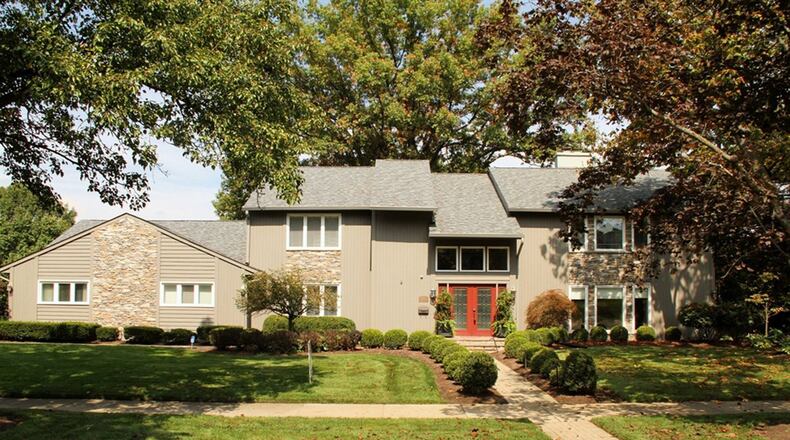 Volume ceilings, a first-floor main bedroom suite, updated kitchen and an open floor plan are a few highlights of this 2-story stone-and-cedar house in Oakwood. CONTRIBUTED PHOTOS BY KATHY TYLER