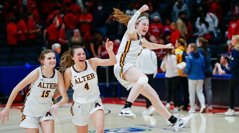 Alter High School senior Caraline Kernan jumps in celebration with teammates Emma Hansley (4) and Riley Smith (12) after their team beat Columbus Bishop Hartley 69-33 on Thursday night at UD Arena to advance to Saturday's Division II state championship game against Thornville Sheridan. CONTRIBUTED PHOTO BY MICHAEL COOPER