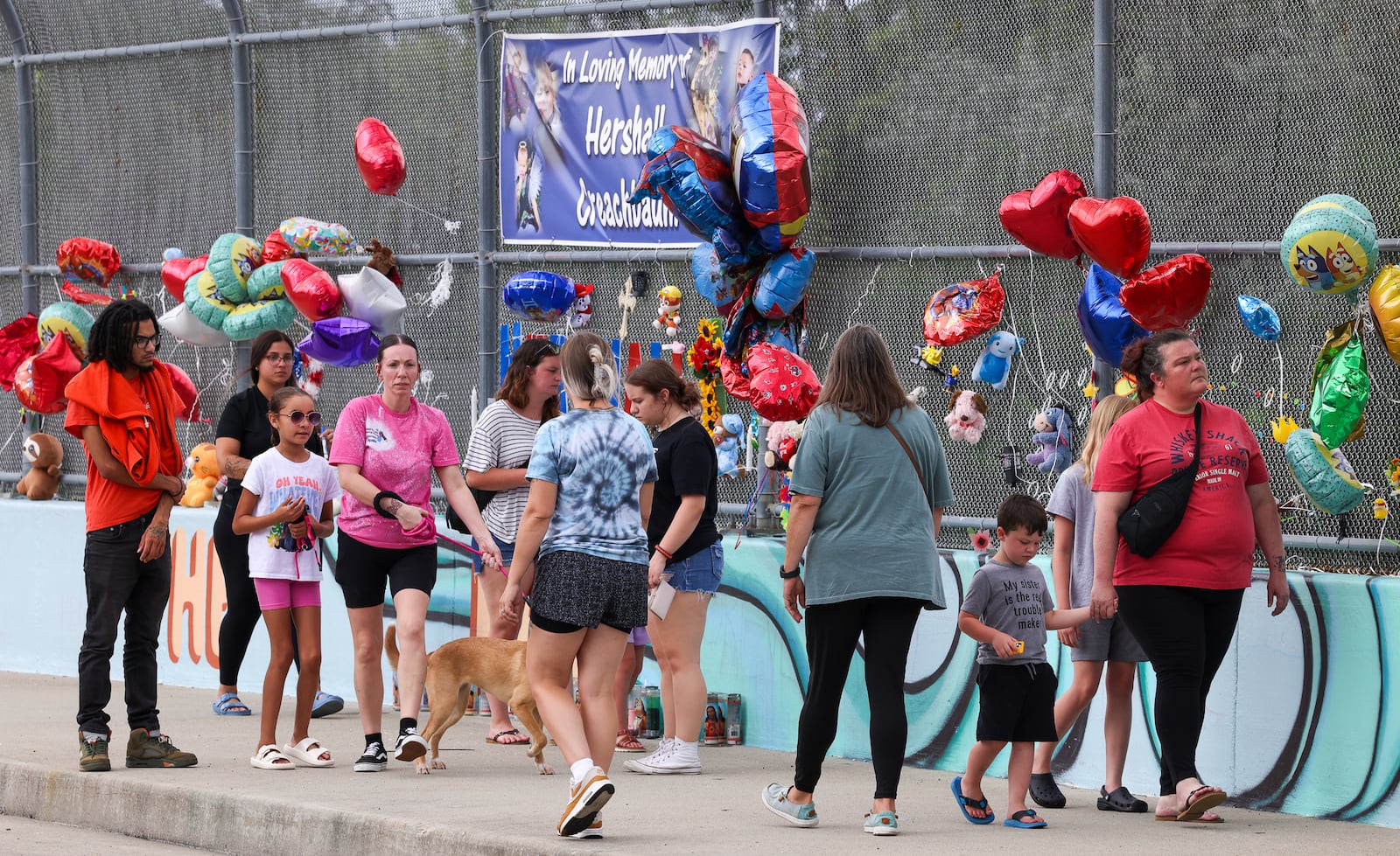 People walk on the McClure Street bridge over U.S. Route 35 on Friday, June 18. A vigil for Hershall Creachbaum Jr., who was found dead last weekend, was held throughout the afternoon and evening. BRYANT BILLING / STAFF