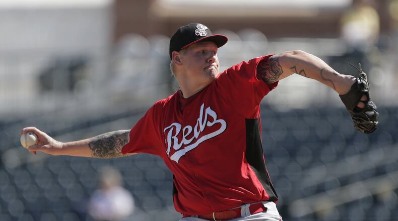Cincinnati Reds starting pitcher Mat Latos throws during an exhibition spring training baseball game against the Kansas City Royals Friday, March 1, 2013, in Surprise, Ariz. (AP Photo/Charlie Riedel)