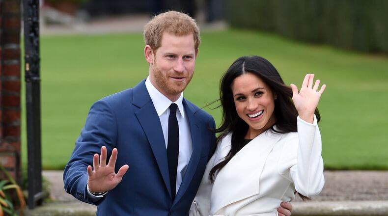 Newly-engaged Prince Harry and Meghan Markle pose during a photoshoot at Kensington Palace.