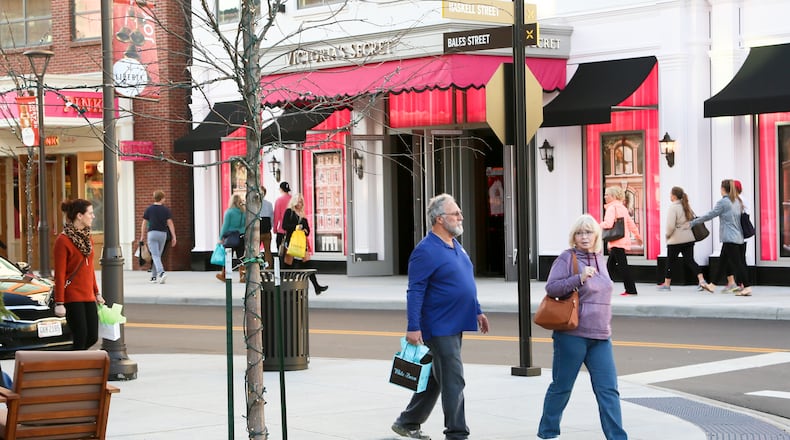 Holiday shoppers enjoy the warm weather as they walk between stores at Liberty Center, Tuesday, Dec. 22, 2015. GREG LYNCH / STAFF