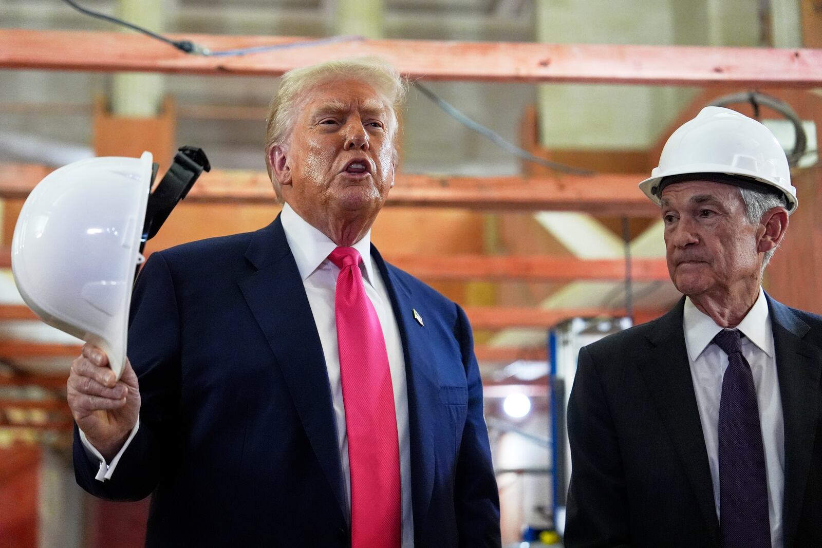 President Donald Trump speaks as Federal Reserve Chairman Jerome Powell listens during a visit to the Federal Reserve, Thursday, July 24, 2025, in Washington. (AP Photo/Julia Demaree Nikhinson)