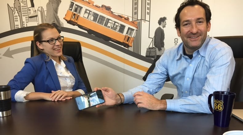 Kaitlyn Nielsen, marketing account director for CommuterAds, with Russ Gottesman, the founder of the company, in their Water Street District offices. THOMAS GNAU/STAFF