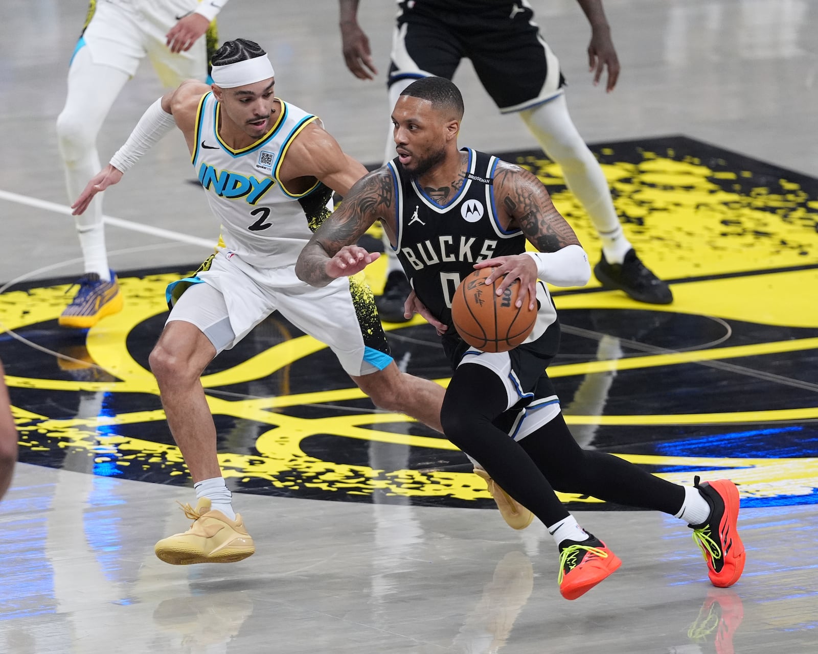 Milwaukee Bucks guard Damian Lillard (0) drives on Indiana Pacers guard Andrew Nembhard (2) during the first half of a first-round NBA basketball playoff game in Indianapolis, Tuesday, April 22, 2025. (AP Photo/Michael Conroy)