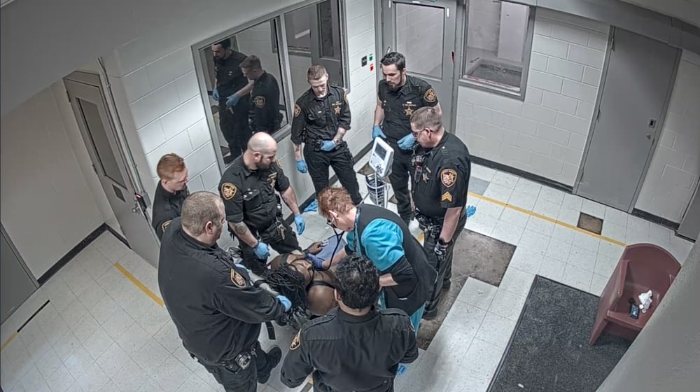 In a still from video provided by the family of Christian Black, Montgomery County Jail staff can be seen checking on Black after he appears to lose consciousness following an altercation with corrections officers.