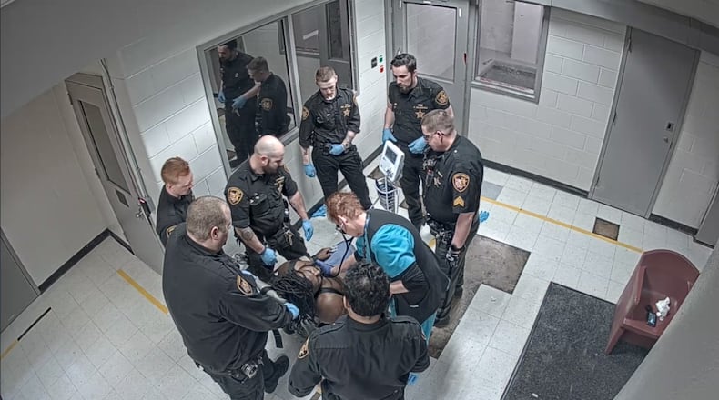In a still from video provided by the family of Christian Black, Montgomery County Jail staff can be seen checking on Black after he appears to lose consciousness following an altercation with corrections officers.