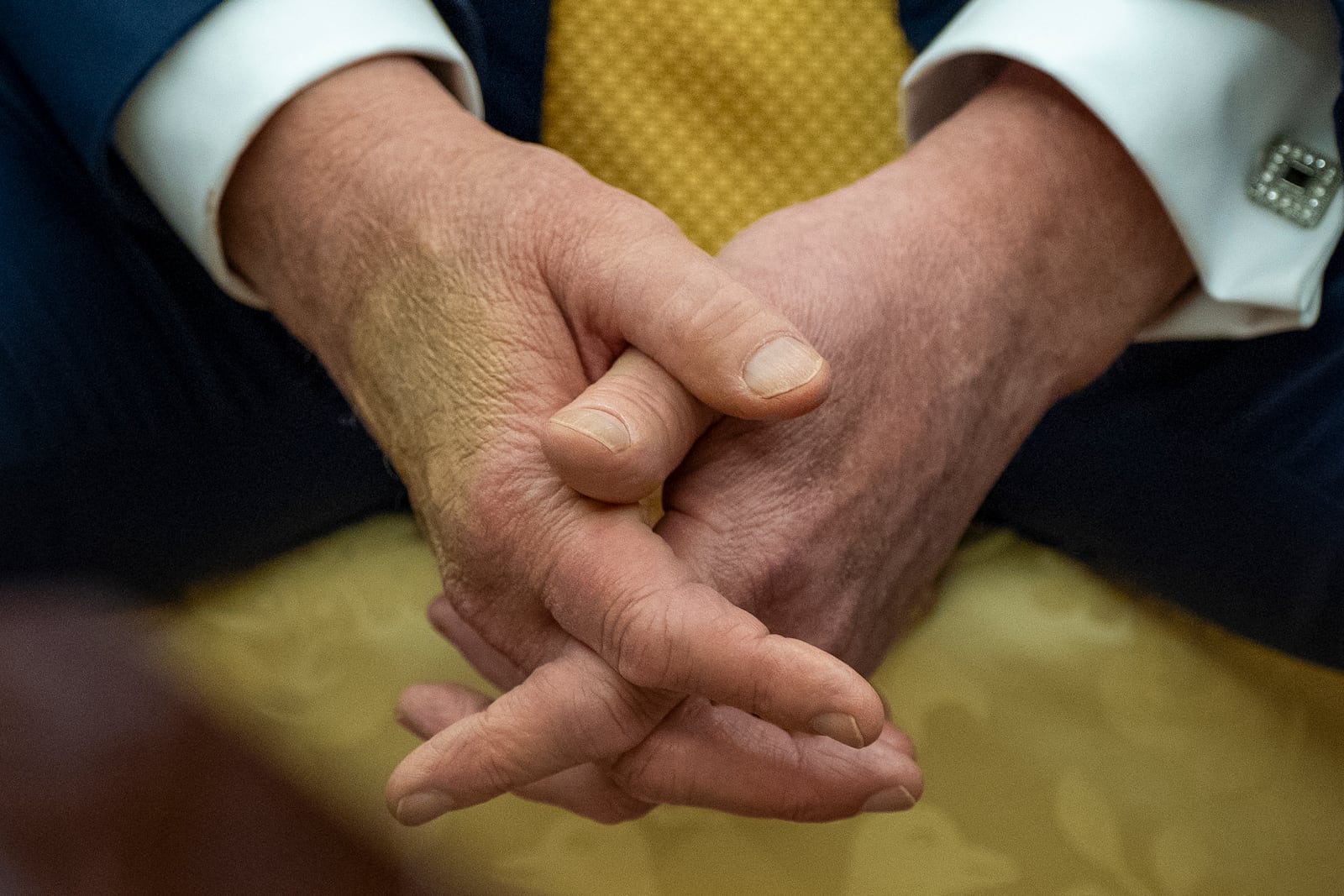 President Donald Trump sits with his hands interlocked as he and Bahrain's Crown Prince Salman bin Hamad Al Khalifa speak in the Oval Office of the White House, Wednesday, July 16, 2025, in Washington. (AP Photo/Alex Brandon)