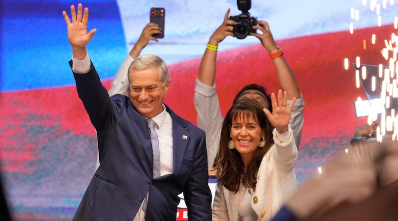 Presidential candidate Jose Antonio Kast, of the opposition Republican Party, and his wife Maria Pia Adriasola wave to supporters after winning the presidential runoff election in Santiago, Chile, Sunday, Dec. 14, 2025. (AP Photo/Matias Delacroix)