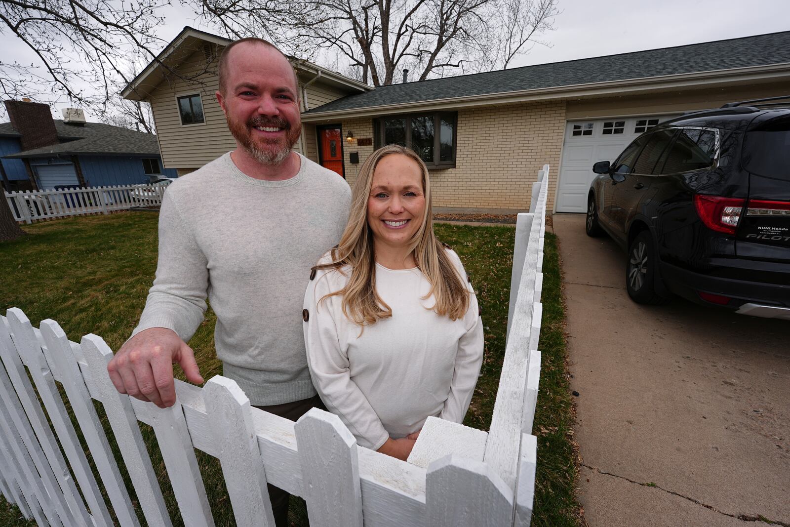 Ryan Vasko and his wife are shown outside the home they just bought after moving from Oregon Thursday, April 3, 2025, in Littleton, Colo. (AP Photo/David Zalubowski)