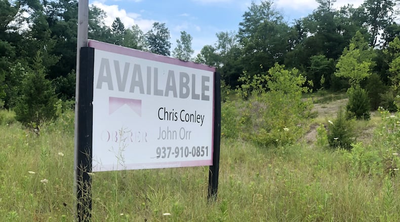 An Oberer sign advertising vacant land along Needmore Road, near the intersection of Old Troy Pike. Oberer proposes building 256 new homes and possibly multi-family housing along Old Troy Pike. CORNELIUS FROLIK / STAFF