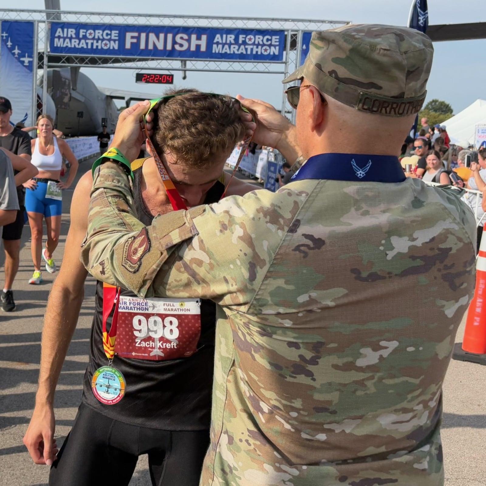 Air Force Marathon men's champion Zach Kreft receives his medal immediately after the race on Saturday morning at Wright Patterson Air Force Base. TOM ARCHDEACON
