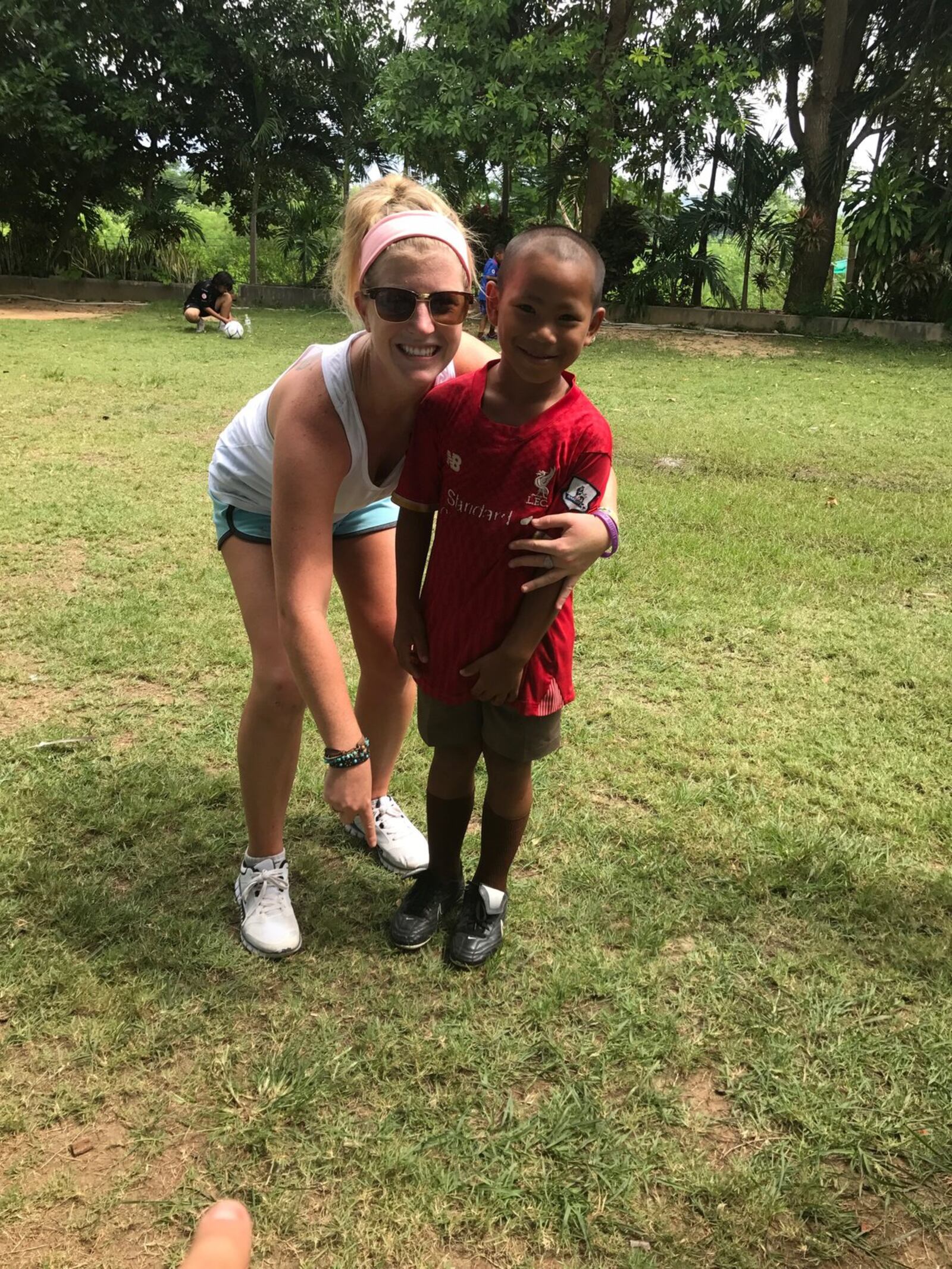 Thai boy receives his pair of cleats from Colleen Williams of SistaSoccer. CONTRIBUTED PHOTO