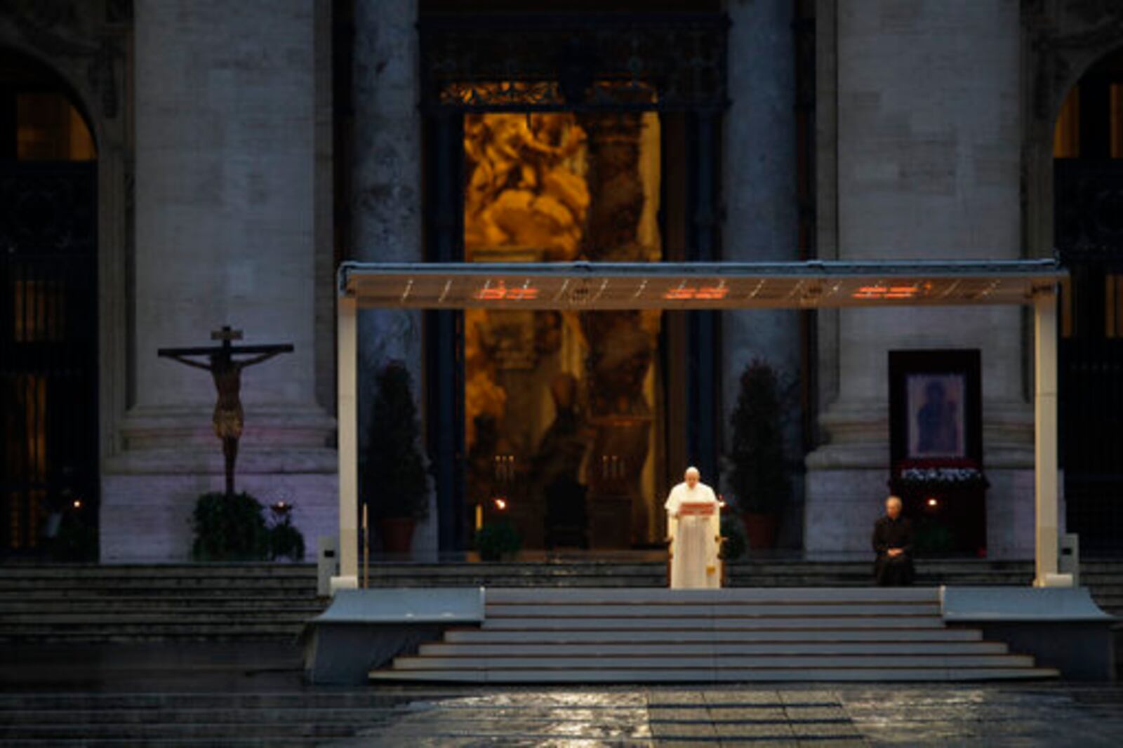 FILE - Pope Francis, standing alone at center, delivers an Urbi et orbi prayer from the empty St. Peter's Square, at the Vatican, Friday, March 27, 2020. “We have realized that we are on the same boat, all of us fragile and disoriented, but at the same time, important and needed, all of us called to row together, each of us in need of comforting the other.” (AP Photo/Alessandra Tarantino, File)