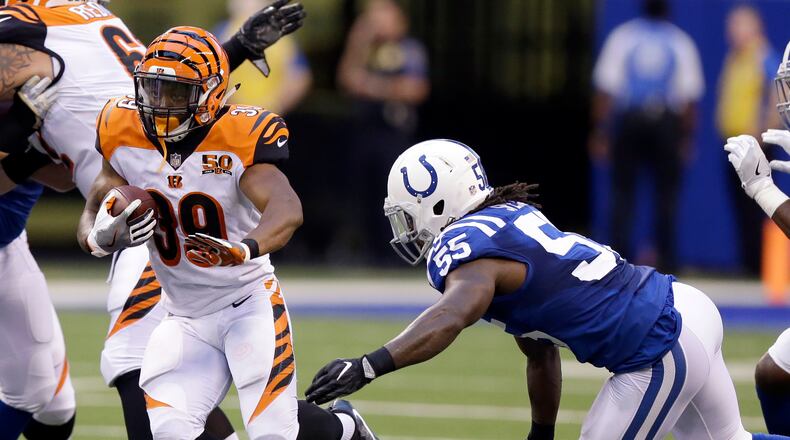 Cincinnati Bengals running back Jarveon Williams, left, runs with the ball as Indianapolis Colts linebacker Sean Spence, right, defends during the first half of a preseason NFL football game in Indianapolis, Thursday, Aug. 31, 2017. (AP Photo/Michael Conroy)