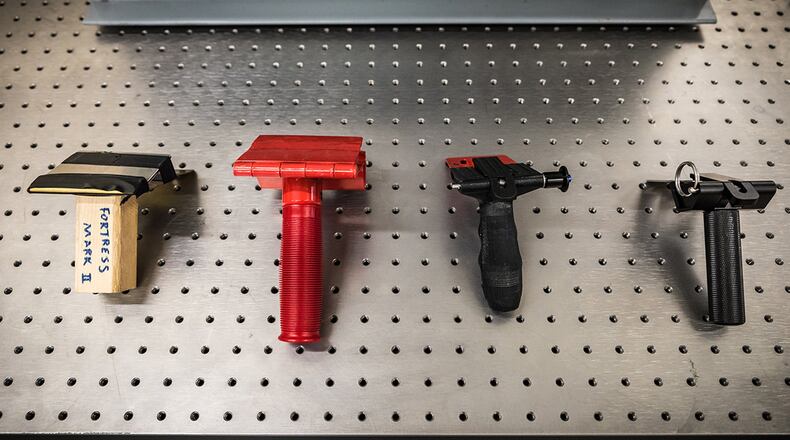 Shown here are four different prototypes of portable door locks at various stages in development. The Air Force Research Laboratory team that developed these has been selected for a 2019 Defense Innovation Award. (U.S. Air Force photo/Richard Eldridge)